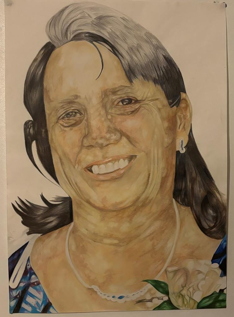 A portrait of a grandmother smiling using pencils.