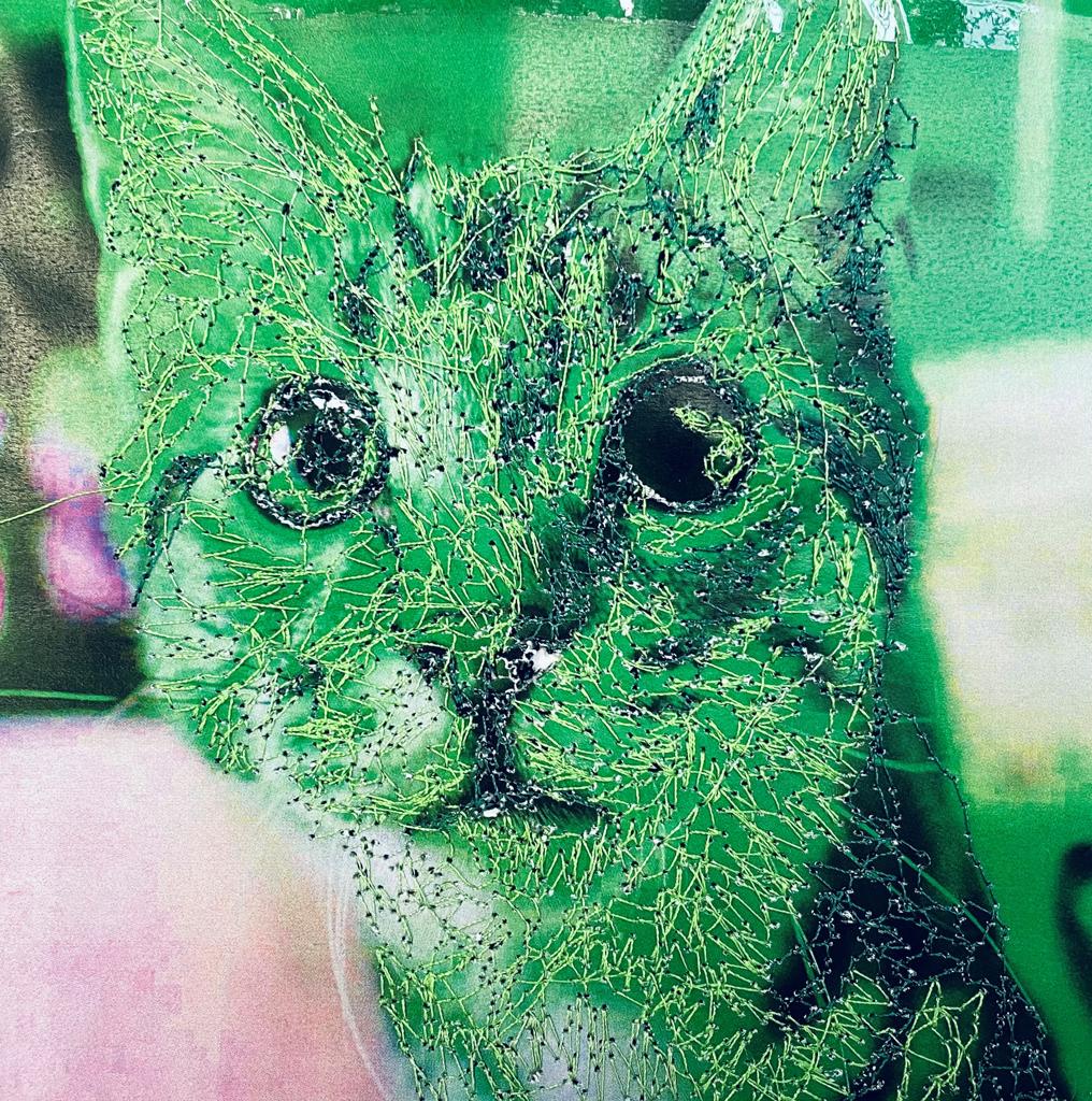 a textile image of a green cat