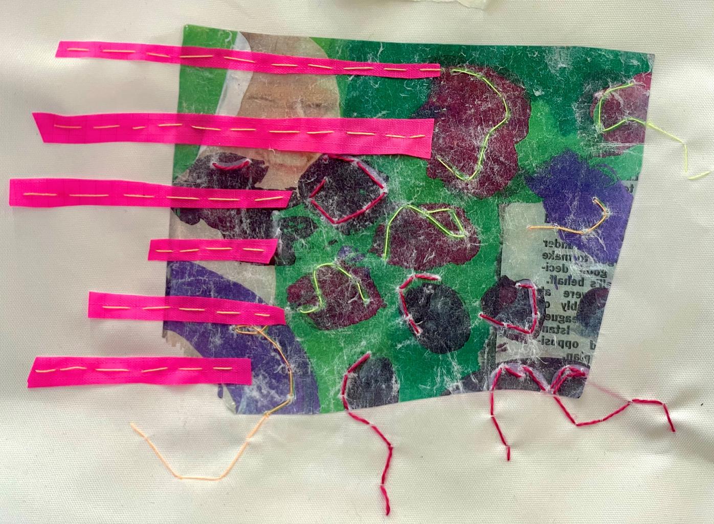 A fabric, thread and image transfer in pink, green and purple of a newspaper cutting of a face and an article
