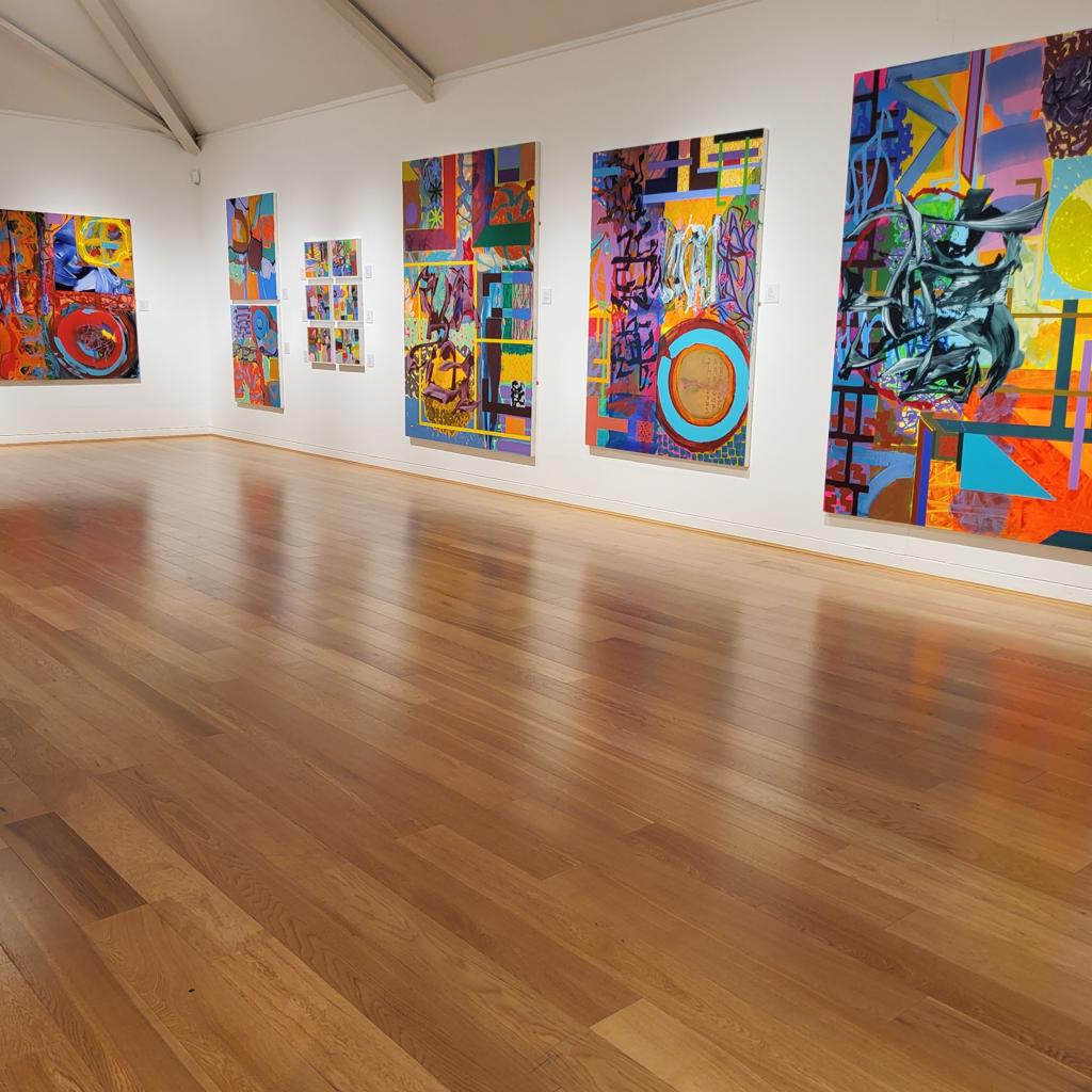 Photograph of the gallery showing six abstract images