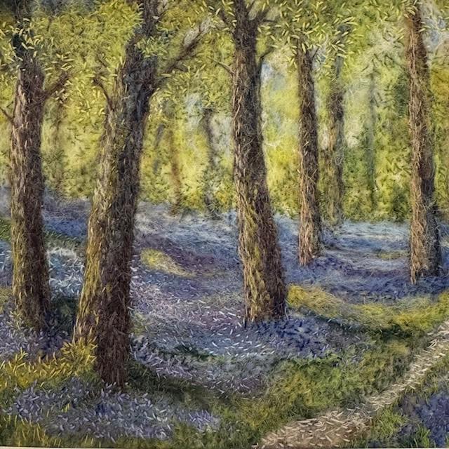 Felting of a forest surrounded by bluebells