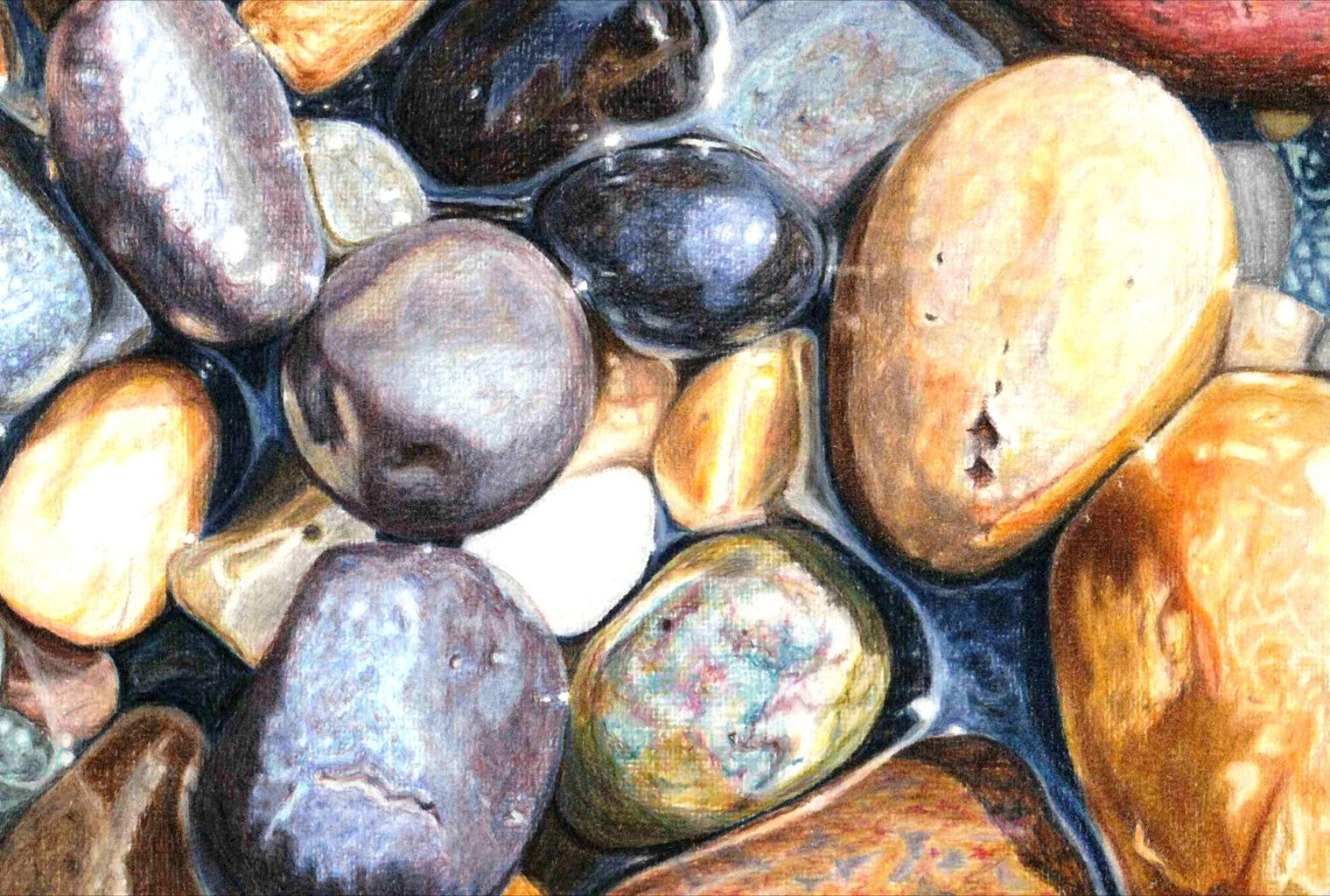 a close up of light coloured pebbles with the sun shining on them.