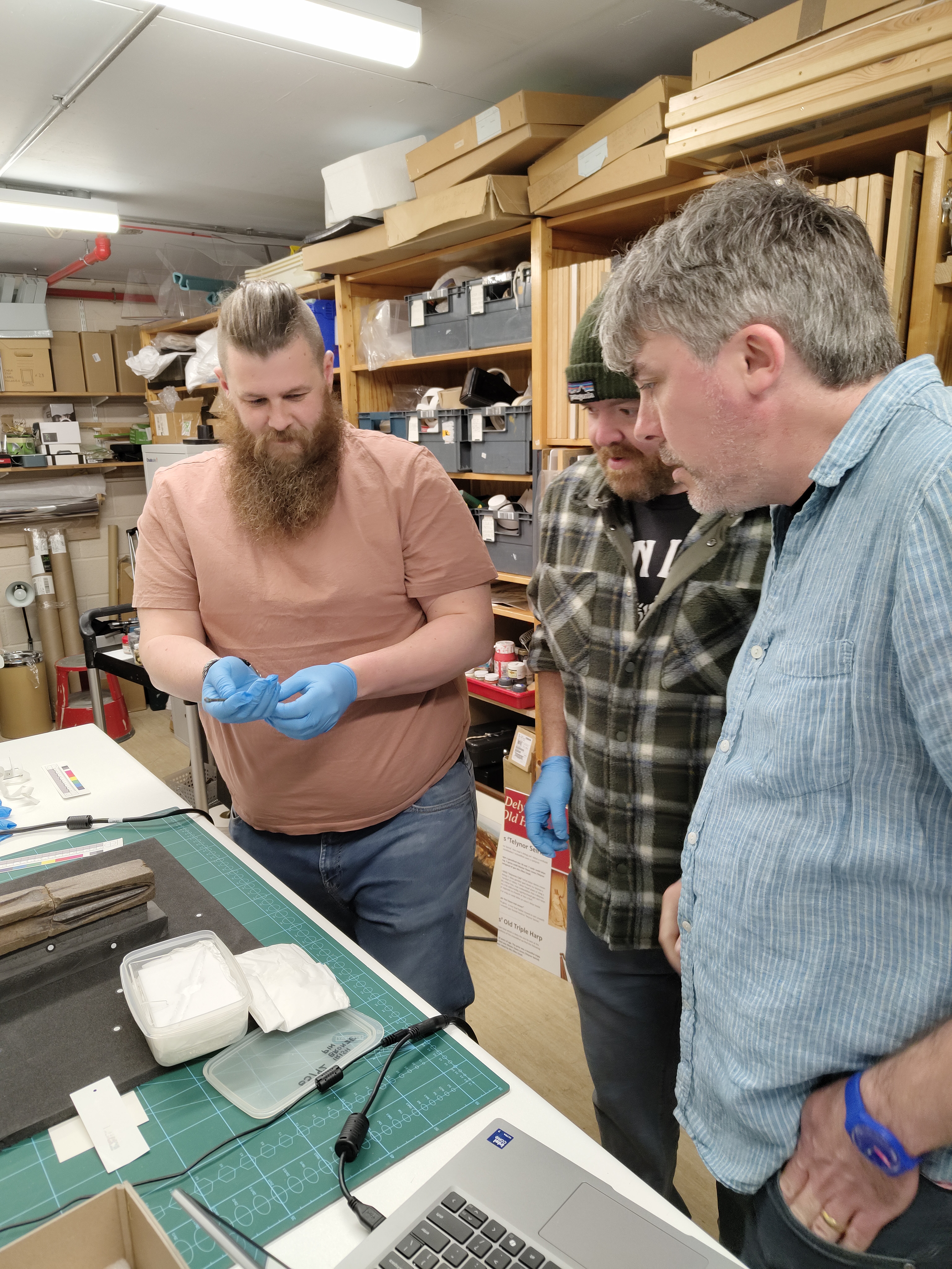 Behind the scenes image of handling objects from the Oriel Môn collection.