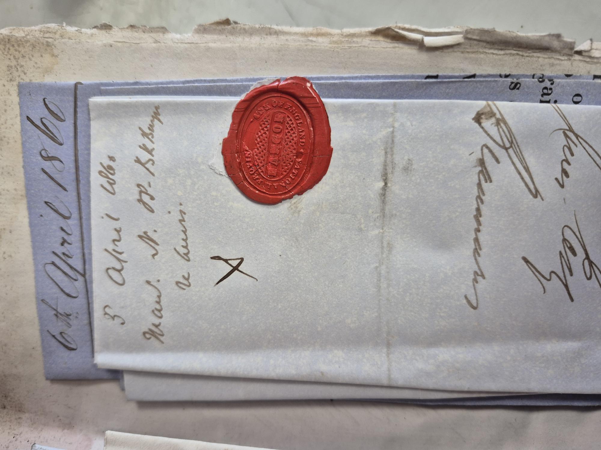 A photograph of an envelope with a wax seal.