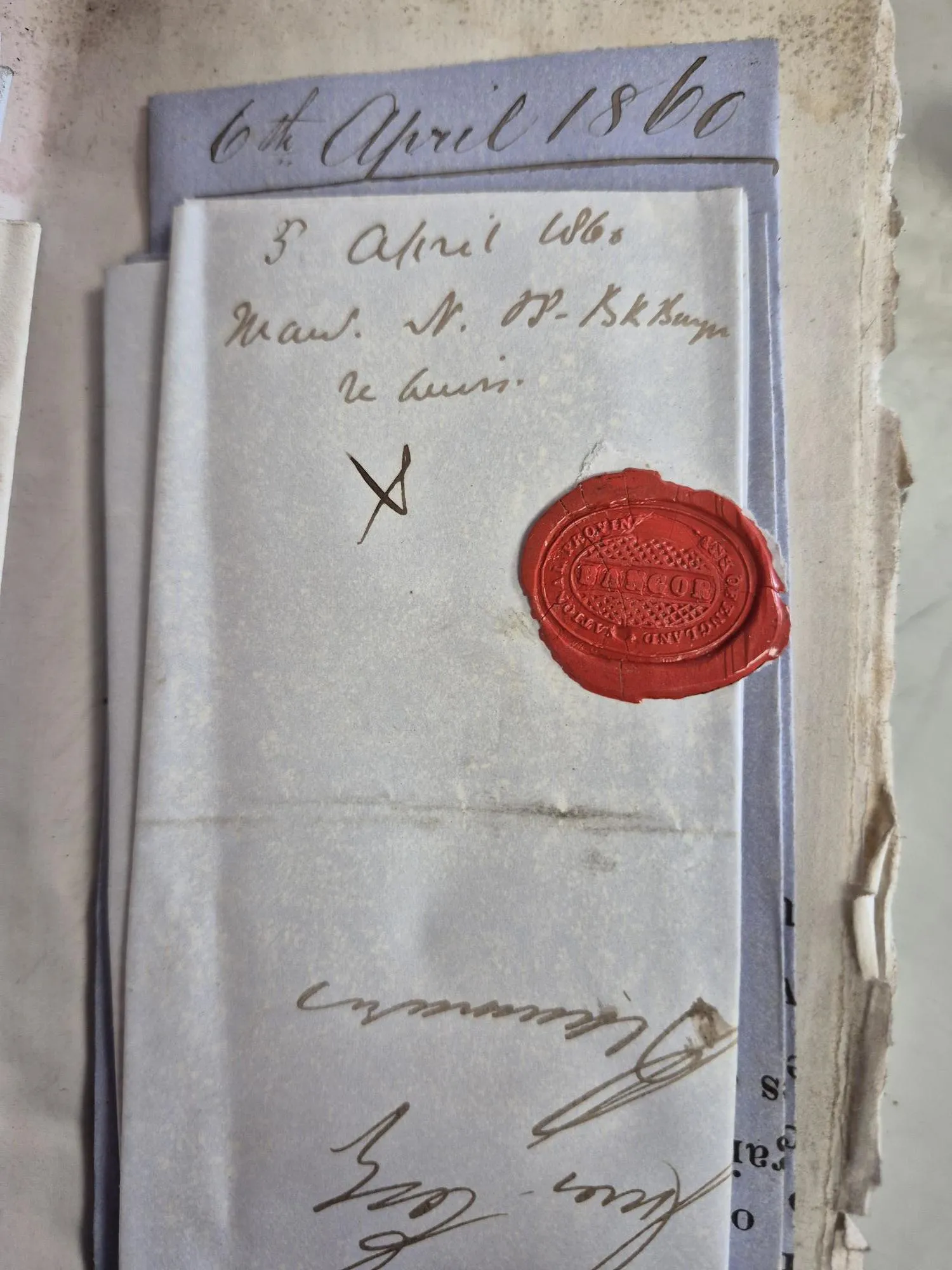 A photograph of an envelope with a wax seal.