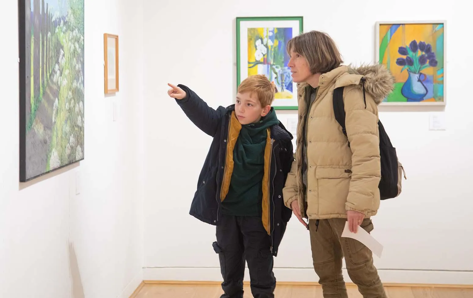 Family looking at a landscape painting