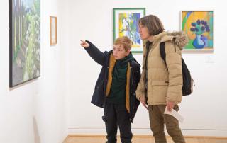 Family looking at a landscape painting