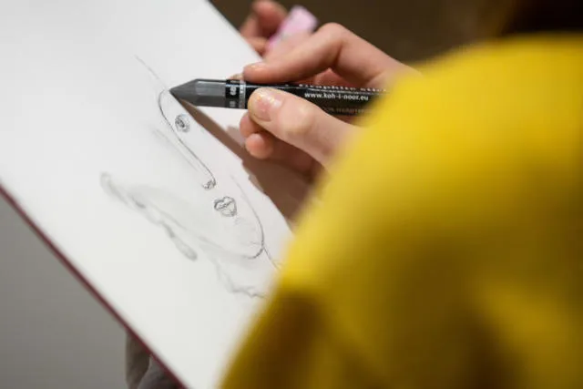 A person sketching a face.
