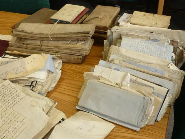 Bundles of old documents on a table.