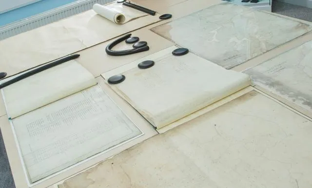 A number of old documents laid out on a table.