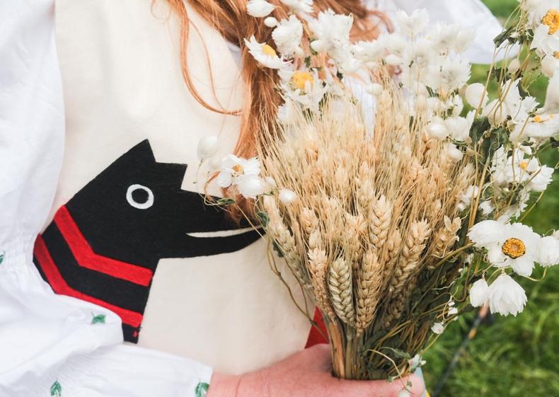 Photograph of a child holding flowers
