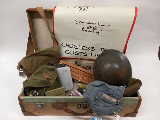 An old case filled with World War II related objects.